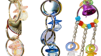 Colorful parrot toys and bird cage mirrors featuring bells and various shapes for bird entertainment.