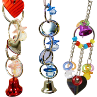 Colorful parrot toys and bird cage mirrors featuring bells and various shapes for bird entertainment.