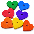 Colorful heart-shaped wood bird toy parts for parrot enrichment, featuring red, green, blue, purple, yellow, and orange pieces.
