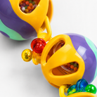 Colorful plastic parrot toy with beads and foraging holes, designed for bird enrichment and play.