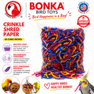 Colorful crinkle shred paper bird toy for foraging, made of soft, safe material in blue, pink, yellow, and black