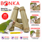 Green parrot chewing natural palm leaf and seagrass bird toy for shredding, chewing, and exploration