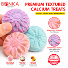 Bonka Bird Toys calcium treats in pink, purple, and blue floral shapes for beak health and enrichment